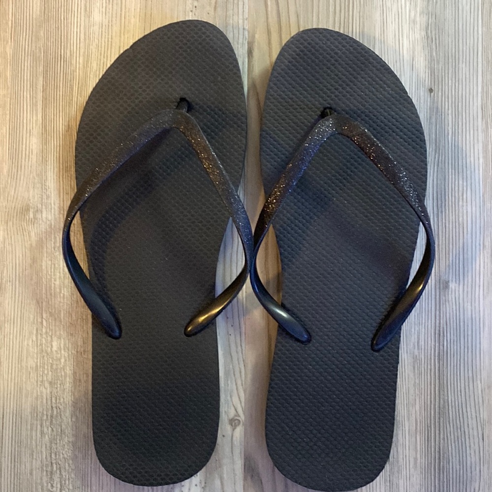 These are U.S. shoe size 11 black flip flops.